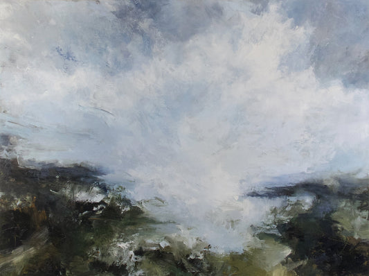 Green coast with bay in the centre and clouds overhead