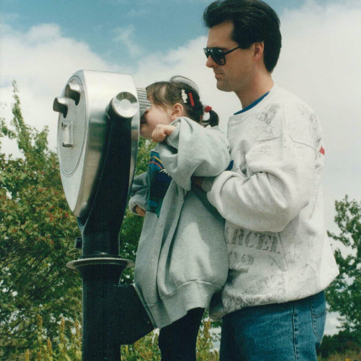 Megan with her father looking through binoculars