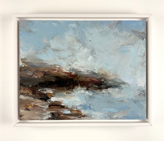 Brown cliff with light blue sea and sky