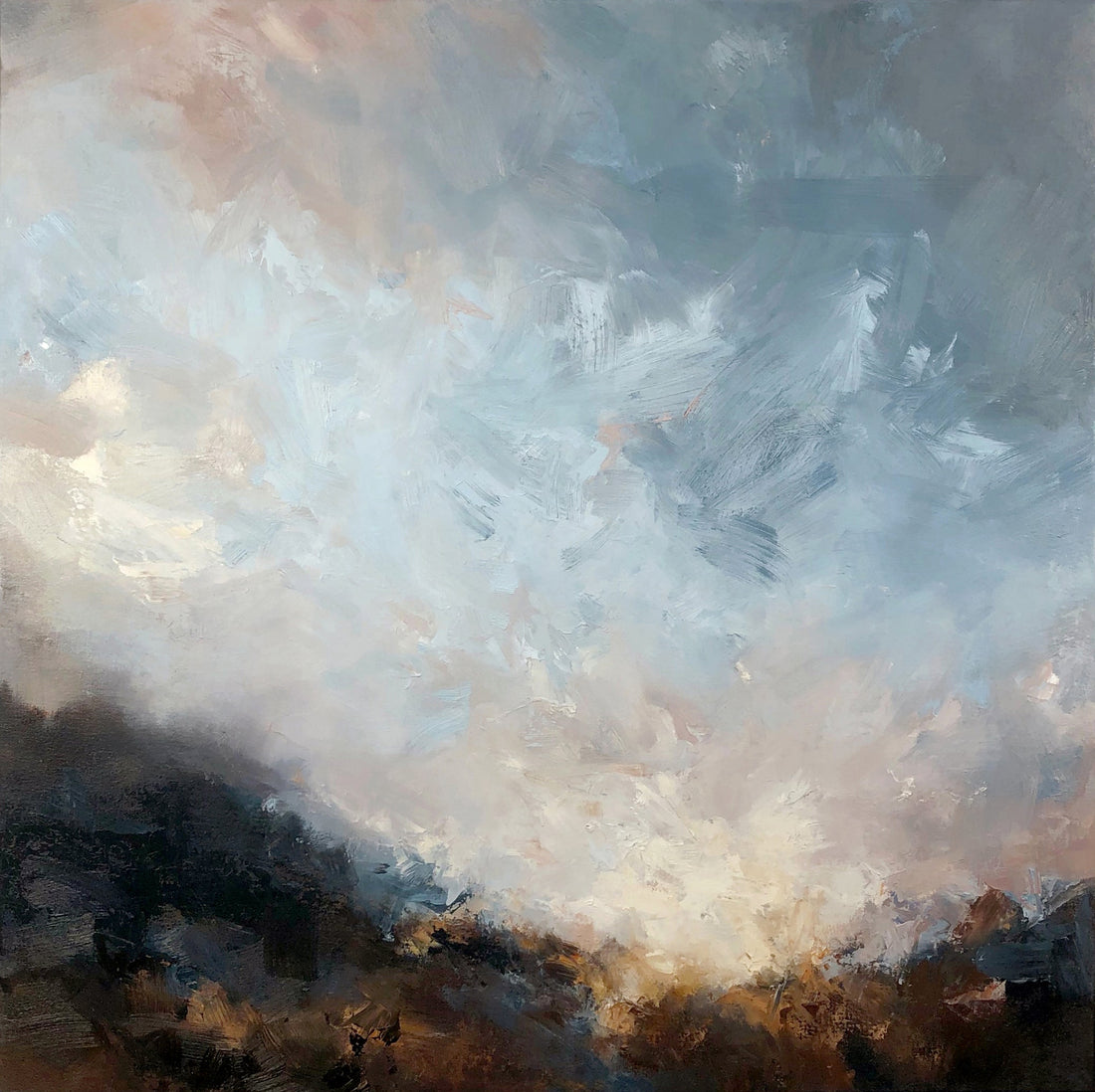 Dark landscape in foreground with pink and blue sunset sky