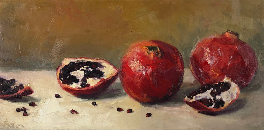Pomegranates and their seeds on yellow ochre and white background