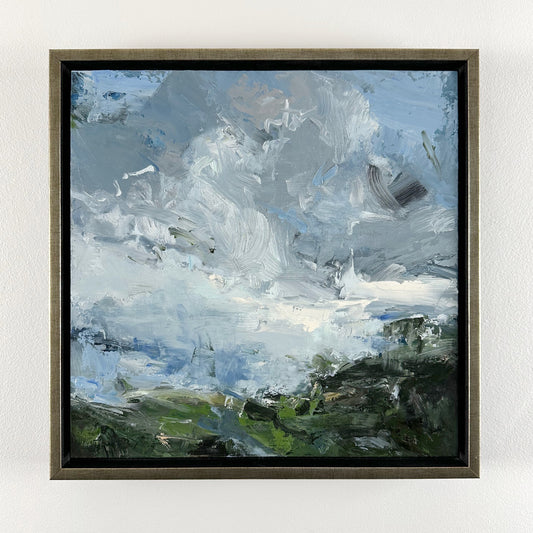Dark green coast with active blue sky and clouds